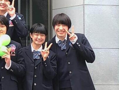 制服で卒業生と一緒に写真をとる石川選手